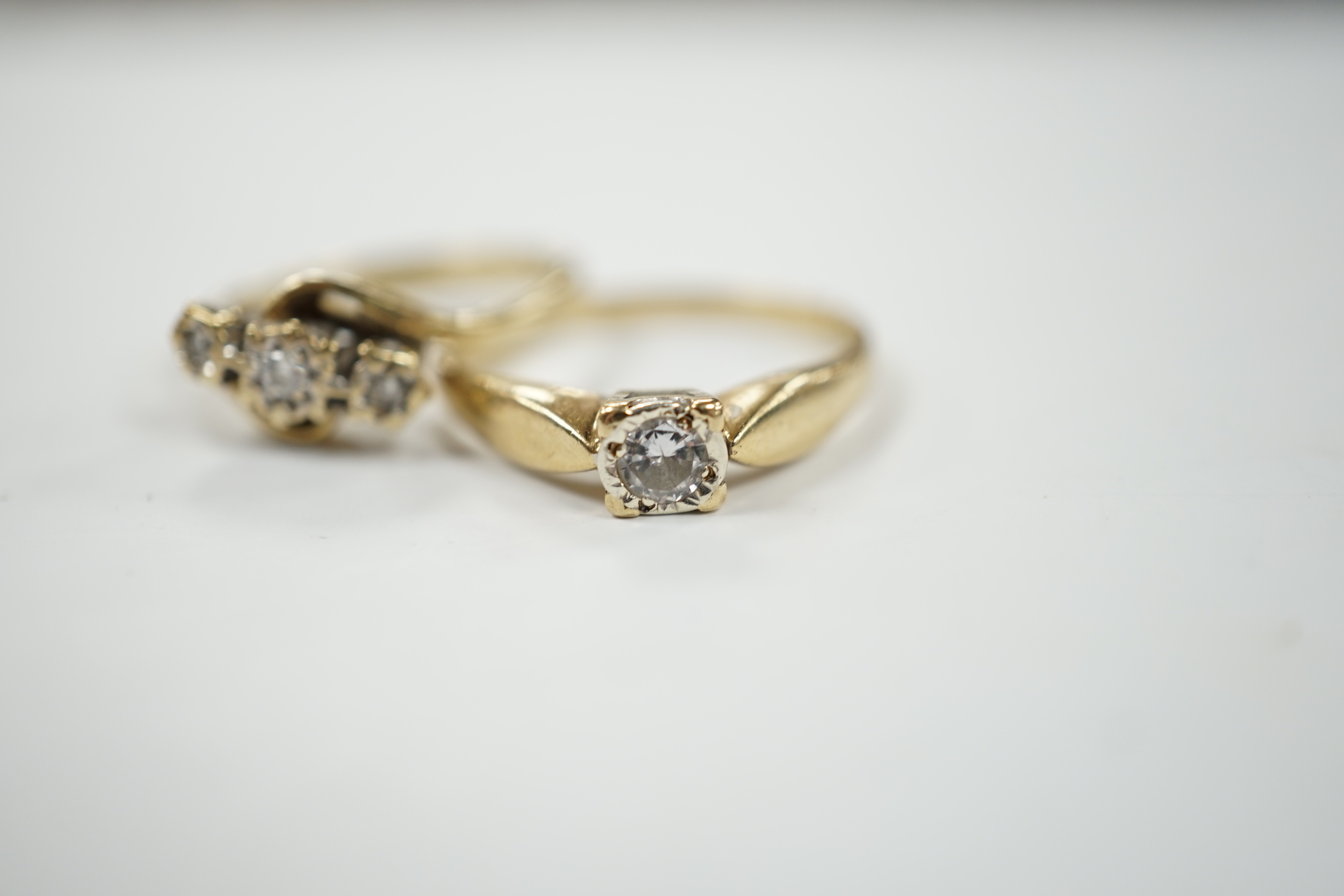 Two 9ct gold and diamond set rings including three stone and solitaire